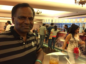 enjoying the free food and drinks. bangalore, india. may 2015.