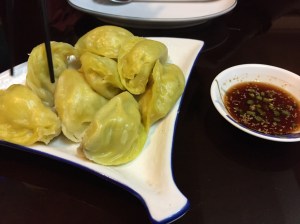 pork dumplings with sauce. bangalore, india. june 2015.