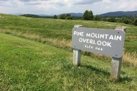 photo of a sign reading pine mountain overlook in a field.